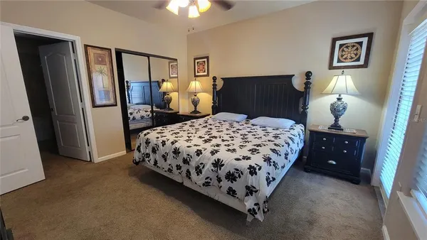 a bedroom with a bed painting on wall and a shower