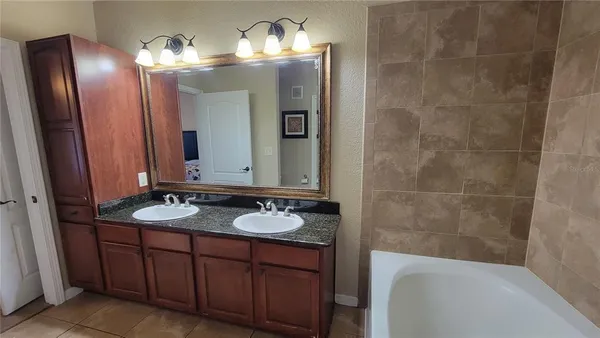 a bathroom with a double vanity sink and a mirror
