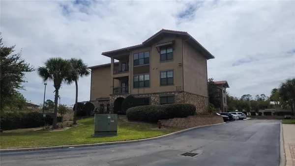 a front view of a house with garden and plants