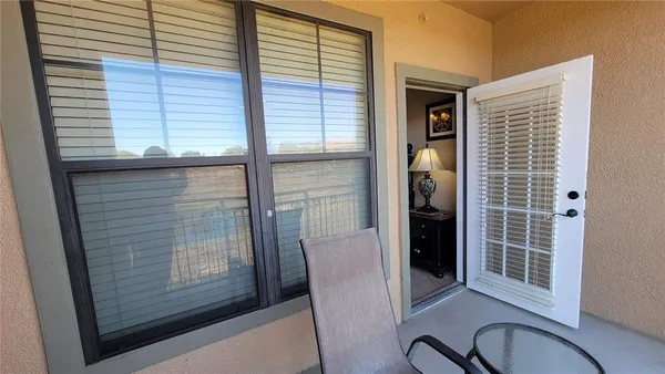 a view of a door and chair in the balcony