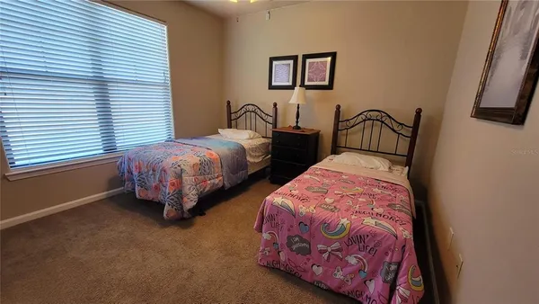 a bedroom with two beds and a window