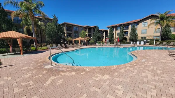 a view of a house with swimming pool and sitting area