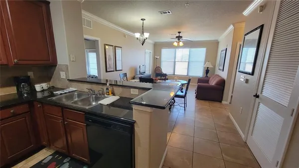 a kitchen with granite countertop a sink stove and cabinets