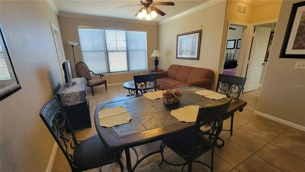 a view of a dining room with furniture and a chandelier