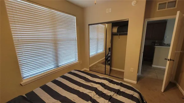 a view of a bedroom with wooden floor and a window