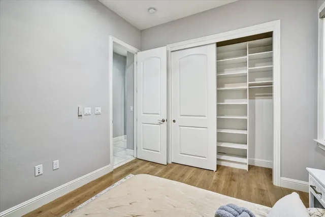 a view of empty room with wooden floor