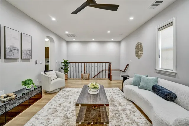 a living room with furniture and wooden floor
