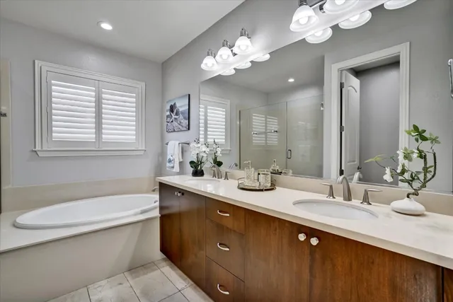a bathroom with a double vanity sink and a mirror