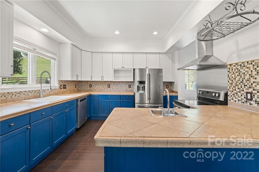 770 Grindstone Road Waynesville, NC 28785 - Photo 11 of 48 a kitchen with kitchen island granite countertop a sink a counter top space and stainless steel appliances