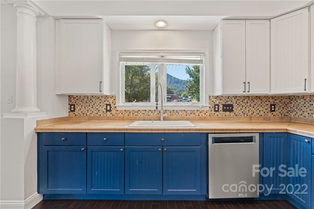 770 Grindstone Road Waynesville, NC 28785 - Photo 13 of 48 a kitchen with granite countertop a sink and a white wooden cabinets