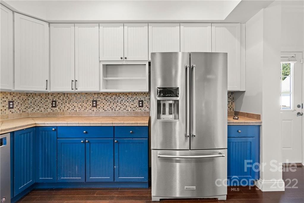 770 Grindstone Road Waynesville, NC 28785 - Photo 14 of 48 a kitchen with granite countertop wooden cabinets and stainless steel appliances