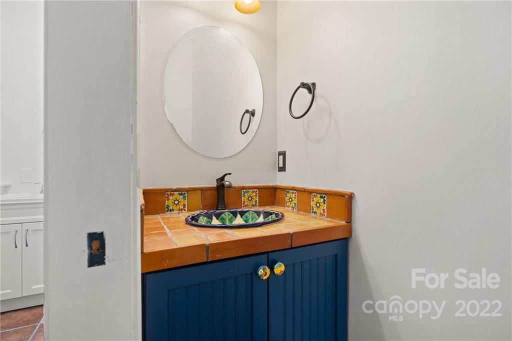770 Grindstone Road Waynesville, NC 28785 - Photo 18 of 48 a bathroom with a sink and a mirror