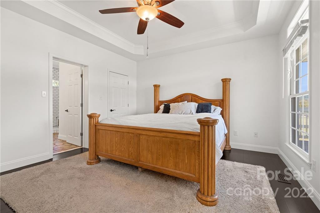 770 Grindstone Road Waynesville, NC 28785 - Photo 20 of 48 a bed room with a bed and a ceiling fan