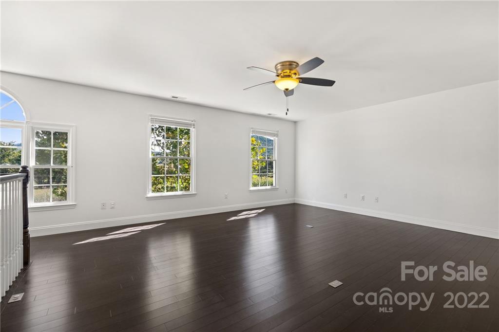 770 Grindstone Road Waynesville, NC 28785 - Photo 26 of 48 a view of an empty room with a window and wooden floor