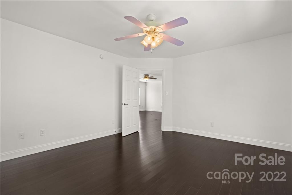 770 Grindstone Road Waynesville, NC 28785 - Photo 31 of 48 an empty room with wooden floor and a ceiling fan