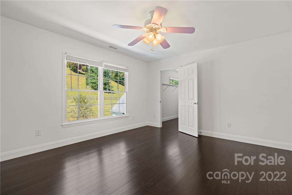 770 Grindstone Road Waynesville, NC 28785 - Photo 32 of 48 a view of an empty room with wooden floor and a window