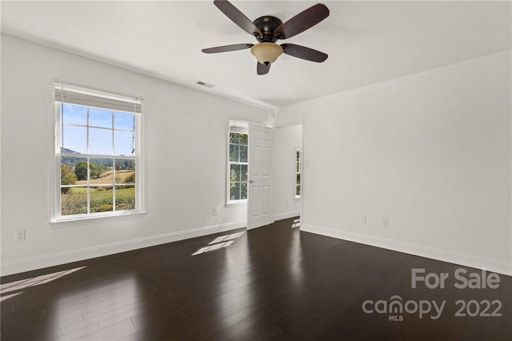 770 Grindstone Road Waynesville, NC 28785 - Photo 33 of 48 a view of an empty room with wooden floor and a window