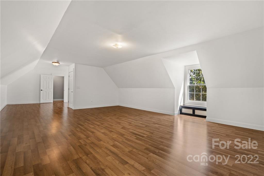 770 Grindstone Road Waynesville, NC 28785 - Photo 37 of 48 wooden floor in an empty room with a window