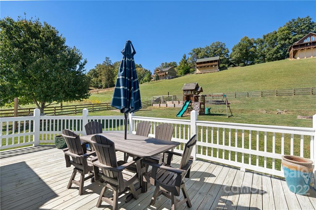 770 Grindstone Road Waynesville, NC 28785 - Photo 41 of 48 a view of a chairs and table on the deck