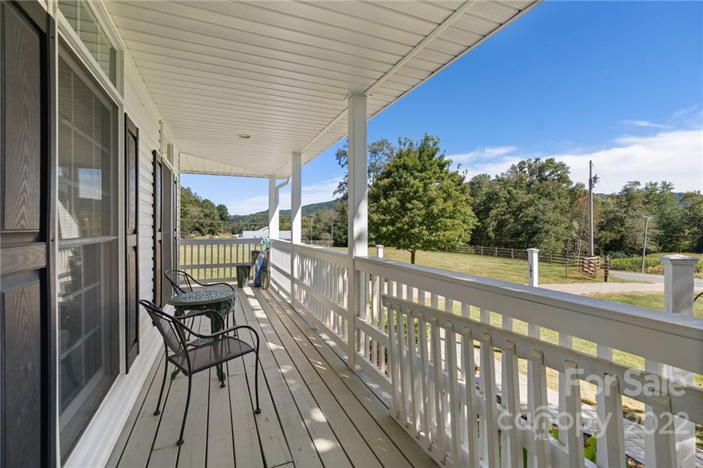770 Grindstone Road Waynesville, NC 28785 - Photo 42 of 48 a view of a balcony with chairs