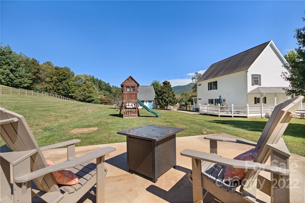 770 Grindstone Road Waynesville, NC 28785 - Photo 43 of 48 a view of a house with backyard porch and furniture
