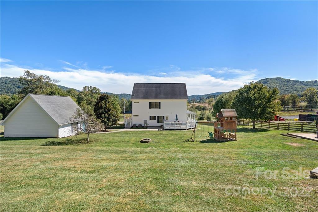 770 Grindstone Road Waynesville, NC 28785 - Photo 47 of 48 a view of a house with a yard and sitting area