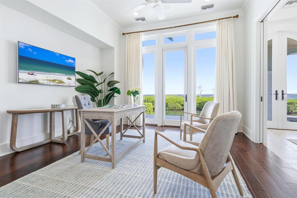 560 Harbor Point Road Longboat Key, FL 34228 - Photo 18 of 64 a dining room with furniture a potted plant and wooden floor