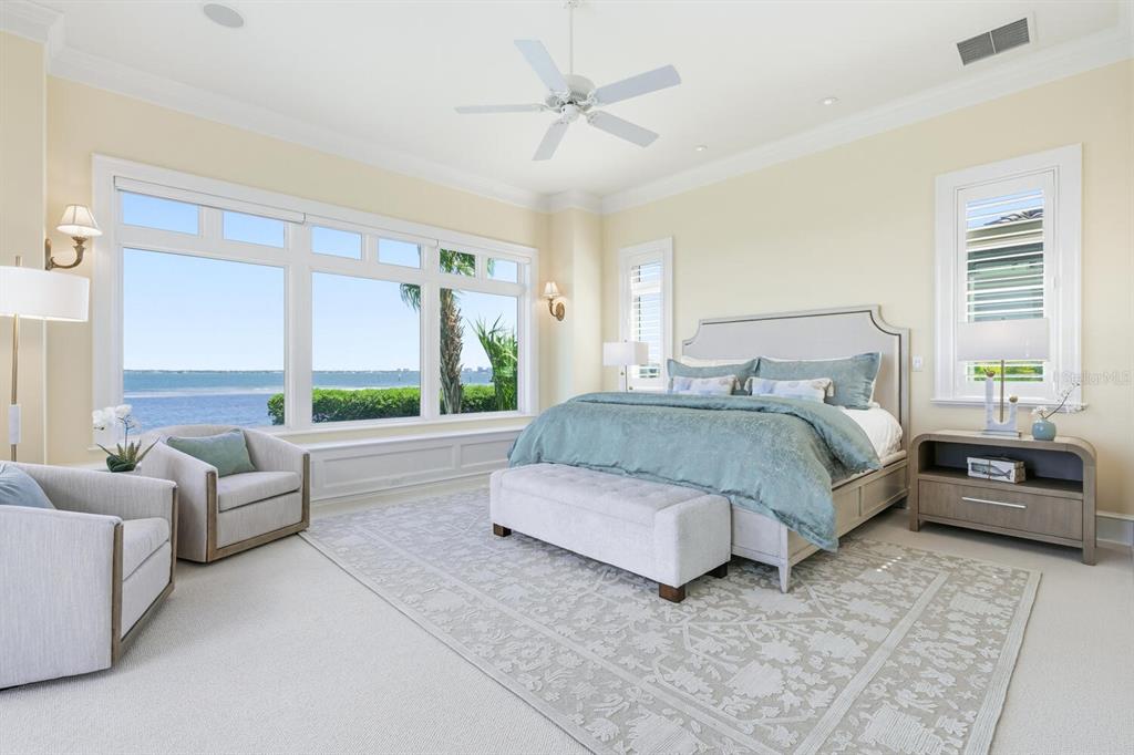 560 Harbor Point Road Longboat Key, FL 34228 - Photo 20 of 64 a bedroom with a bed couch and a large window