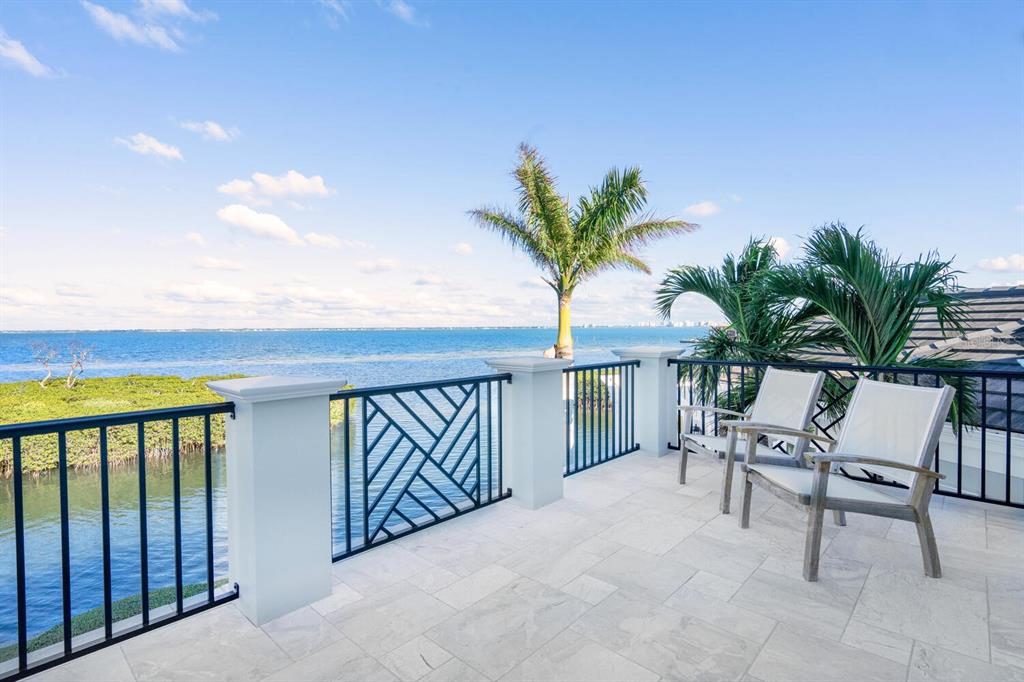 560 Harbor Point Road Longboat Key, FL 34228 - Photo 29 of 64 a view of balcony with furniture and a potted plant