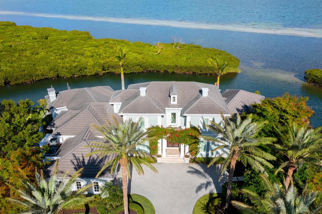 560 Harbor Point Road Longboat Key, FL 34228 - Photo 3 of 64 a view of a swimming pool with a yard