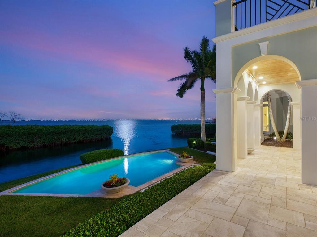 560 Harbor Point Road Longboat Key, FL 34228 - Photo 38 of 64 a view of a house with backyard and a garden