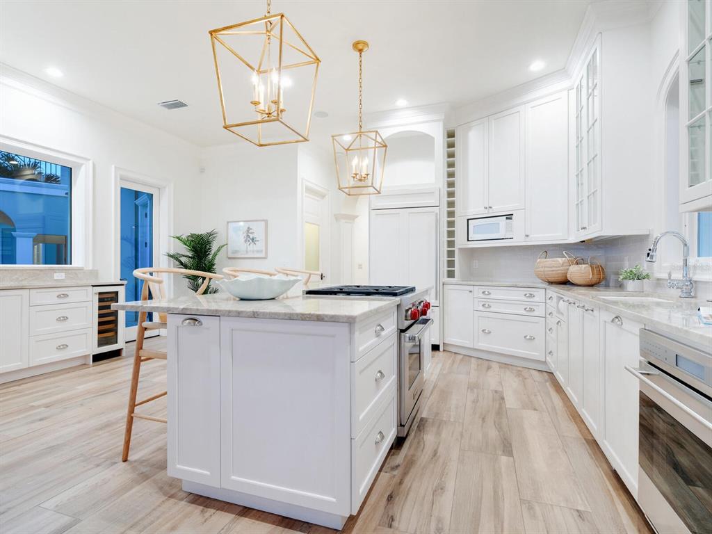560 Harbor Point Road Longboat Key, FL 34228 - Photo 60 of 64 a kitchen with a sink a stove and cabinets