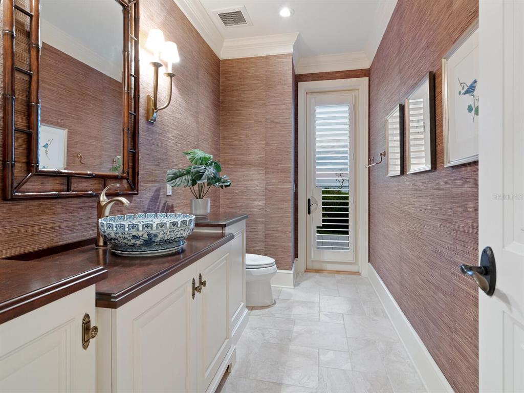 560 Harbor Point Road Longboat Key, FL 34228 - Photo 64 of 64 a bathroom with a granite countertop sink a toilet and shower