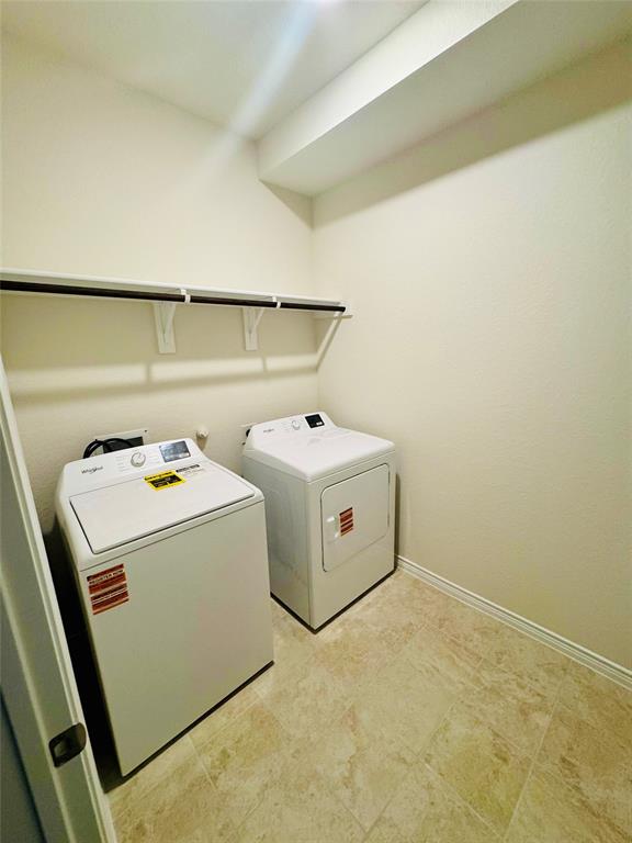 2408 Grapevine Way Celina, TX 75009 - Photo 11 of 20 Laundry area featuring baseboards and washing machine and dryer