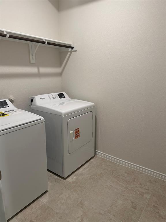 2408 Grapevine Way Celina, TX 75009 - Photo 16 of 20 Laundry room with washing machine and dryer and baseboards