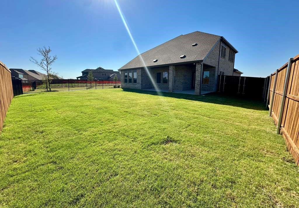 2408 Grapevine Way Celina, TX 75009 - Photo 18 of 20 Back of property featuring brick siding, a patio area, and a fenced backyard