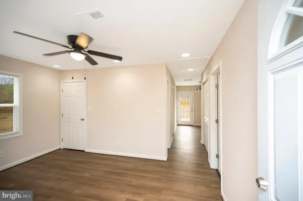 a view of a hallway with wooden floor