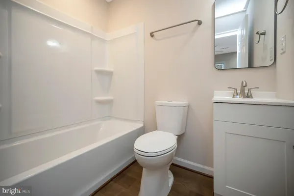 a bathroom with a toilet a sink and bathtub