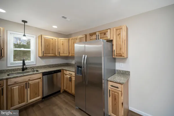 a kitchen with a sink a refrigerator and window