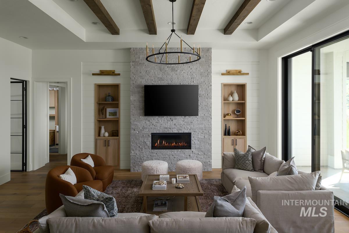 11415 North Misty Ridge Way Boise, ID 83714 - Photo 21 of 46 Living room with healthy amount of natural light, beam ceiling, wood finished floors, built in features, and recessed lighting