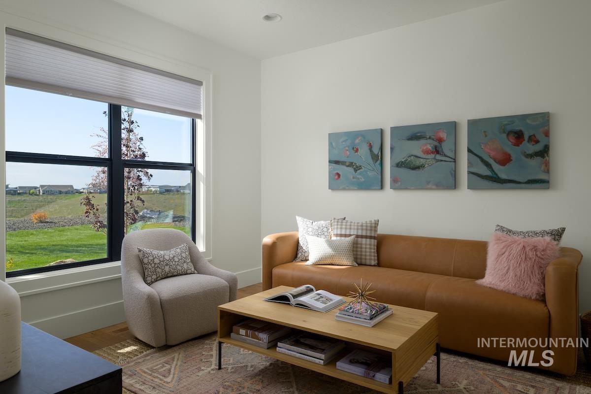 11415 North Misty Ridge Way Boise, ID 83714 - Photo 22 of 46 Living room featuring baseboards and wood finished floors
