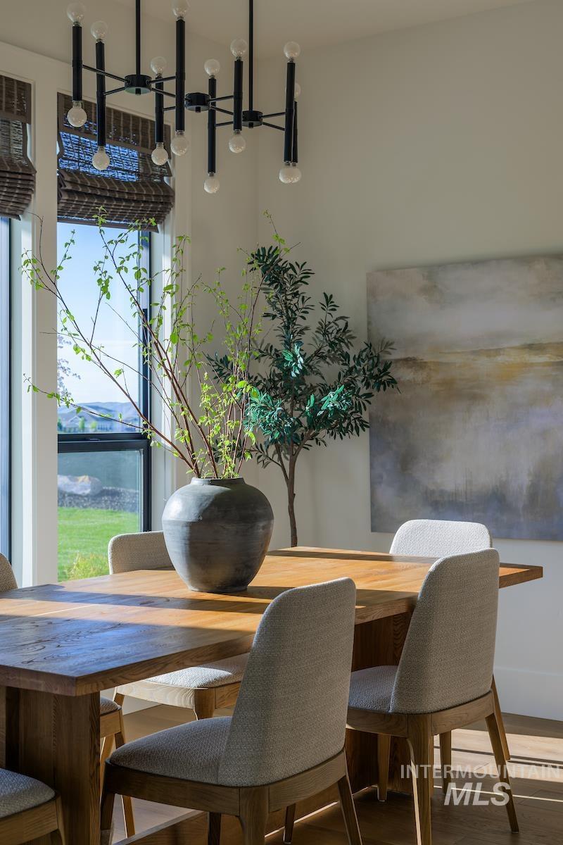 11415 North Misty Ridge Way Boise, ID 83714 - Photo 31 of 46 Dining space featuring wood finished floors and a chandelier