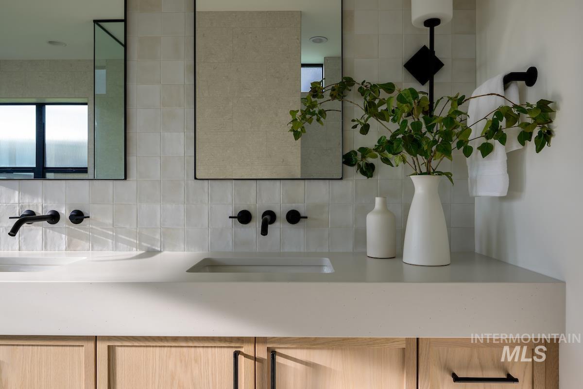 11415 North Misty Ridge Way Boise, ID 83714 - Photo 38 of 46 Bathroom with double vanity and decorative backsplash