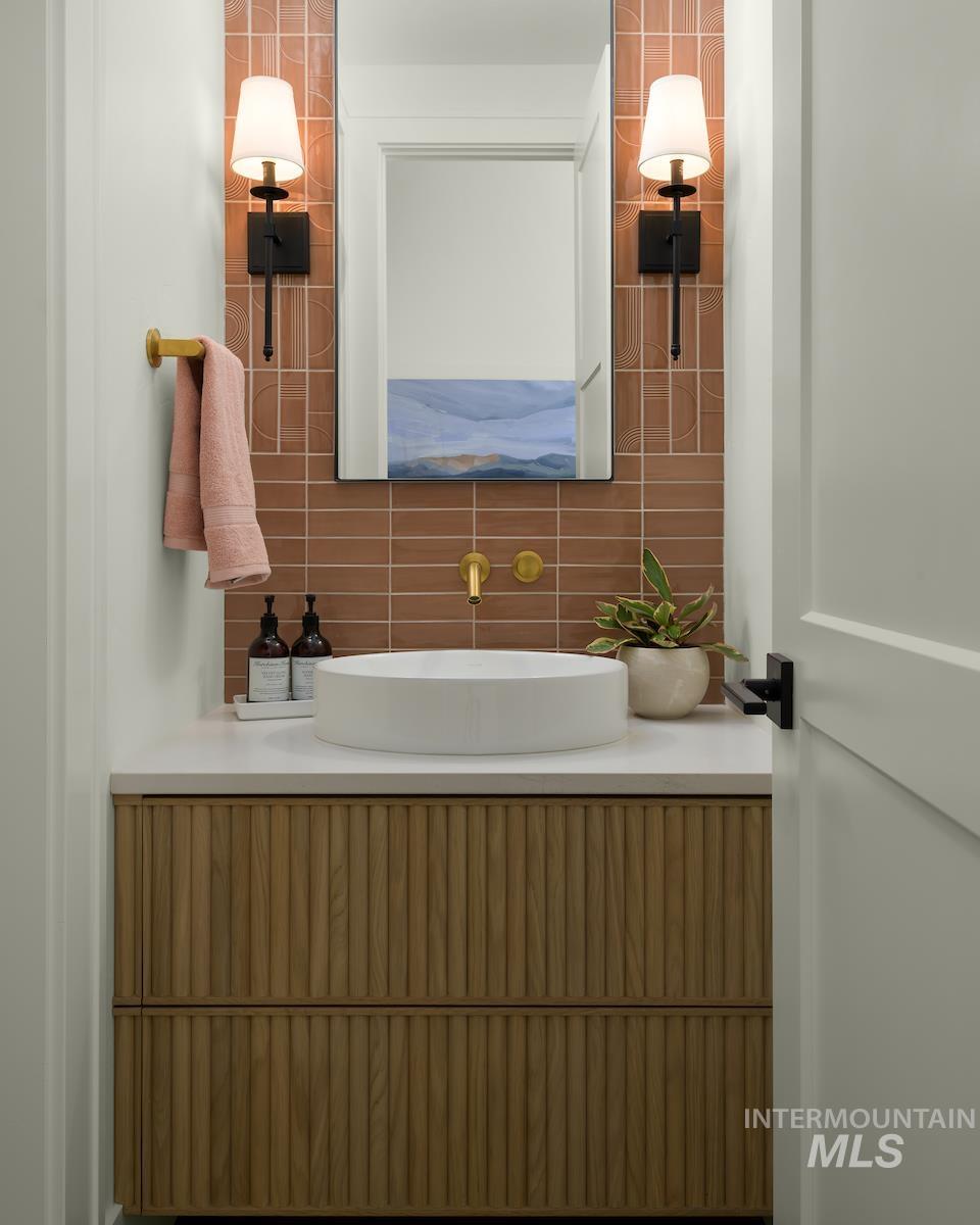 11415 North Misty Ridge Way Boise, ID 83714 - Photo 6 of 46 Bathroom with vanity and tasteful backsplash