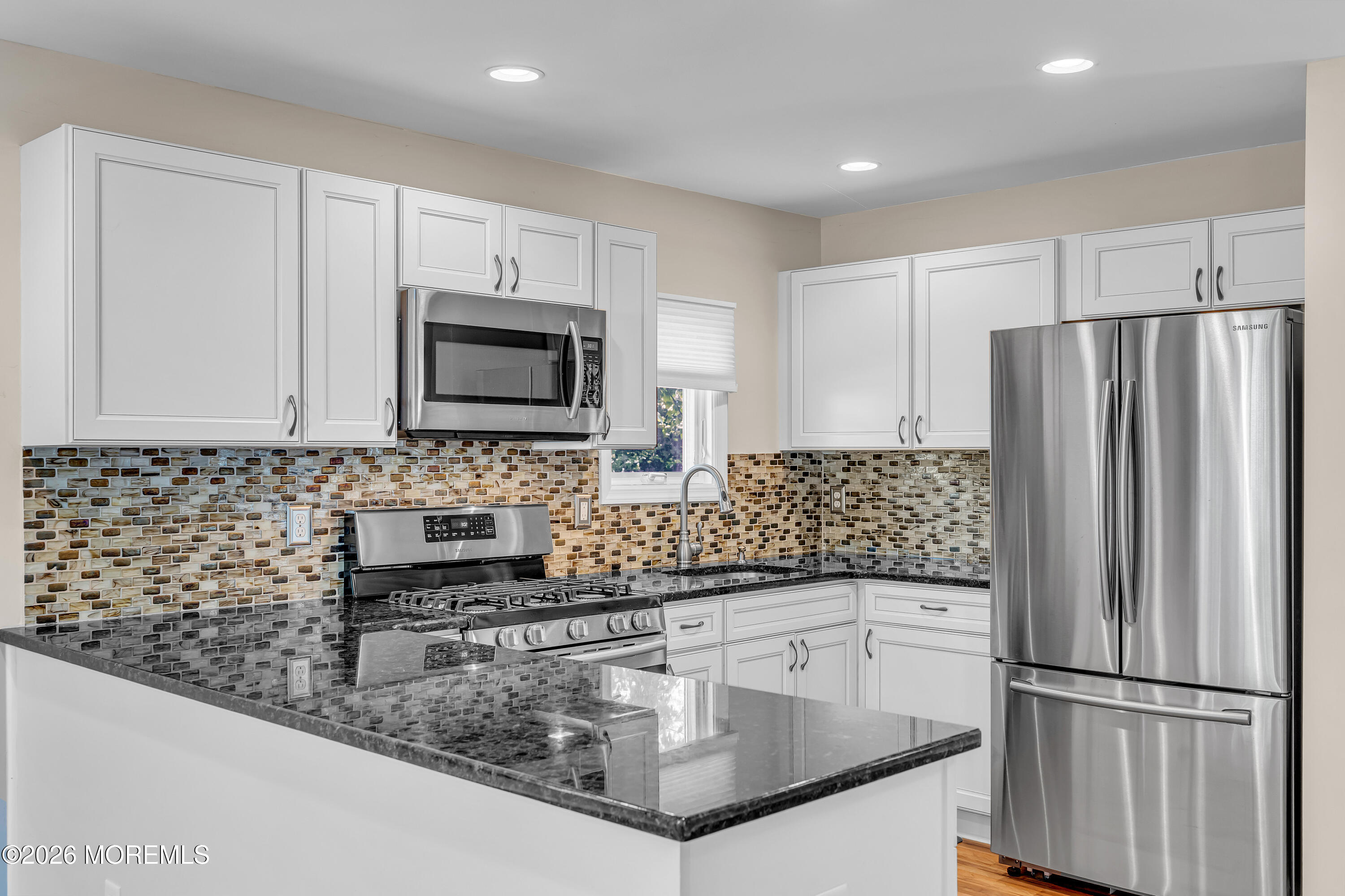 1407 Edgemere Road Wall, NJ 07719 - Photo 2 of 16 a kitchen with stainless steel appliances granite countertop a refrigerator a stove a sink and a microwave