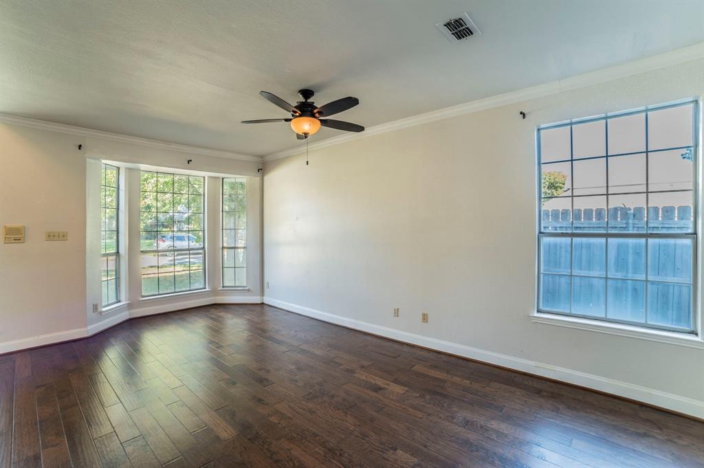 1240 Trinity Drive Benbrook, TX 76126 - Photo 9 of 33 a view of empty room with wooden floor and fan