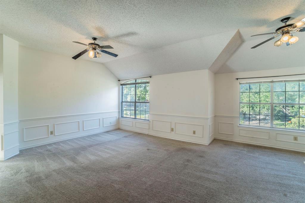 1240 Trinity Drive Benbrook, TX 76126 - Photo 10 of 33 a view of empty room with windows and fan