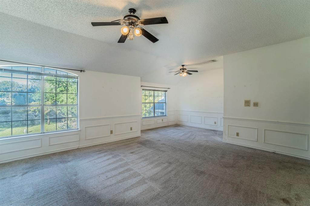 1240 Trinity Drive Benbrook, TX 76126 - Photo 13 of 33 an empty room with windows and fan