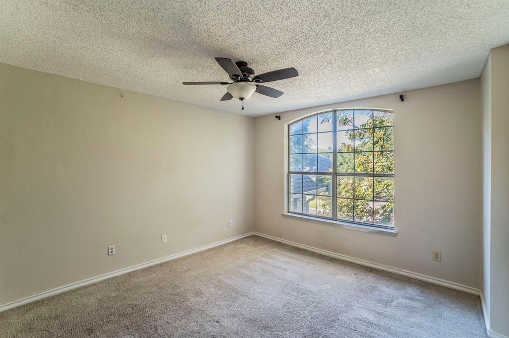 1240 Trinity Drive Benbrook, TX 76126 - Photo 17 of 33 an empty room with a window and a fan