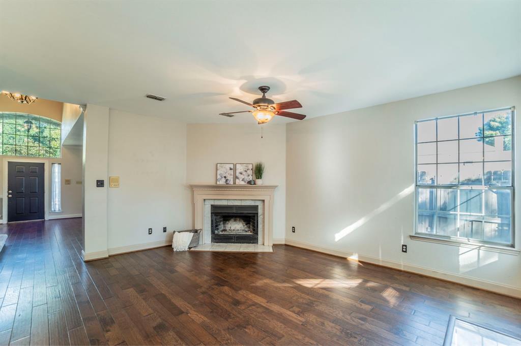 1240 Trinity Drive Benbrook, TX 76126 - Photo 3 of 33 a view of an empty room with a fireplace and a window